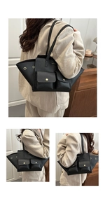 Macro shot of black litchi leather tote with golden buckle pockets and winged side details