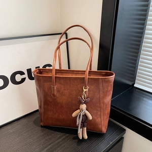 Retro caramel brown tote bag in vintage faux leather with a cute plush rabbit charm