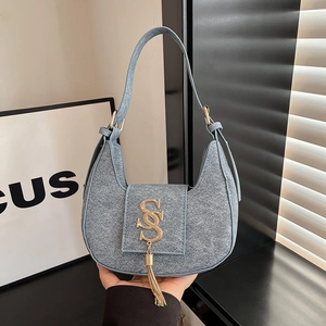 Blue denim crescent underarm bag with gold S-letter pendant and fringe tassels