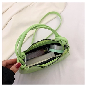 Macro view of green avocado mini crossbody bag showing internal space for daily items
