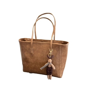 Retro brown large capacity faux leather tote bag with plush rabbit pendant on white background