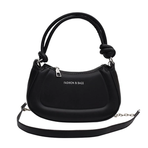 Minimalist black half-moon crossbody bag with decorative knots and chain strap detail