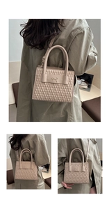 Detail of beige quilted handbag with metal bow decor and adjustable leather strap