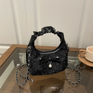 Elegant black pleated cloud bag with bow and pearl detail for crossbody or hand carry