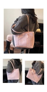 Detail of pink matte tote bag featuring long shoulder straps and spacious trapezoid design