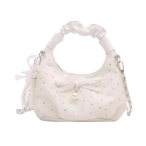 White dumpling handbag with bow, pearls, and silver studs for a sweet lady style