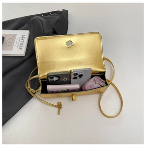 Internal view of gold metallic handbag showing storage capacity for phones and wallet