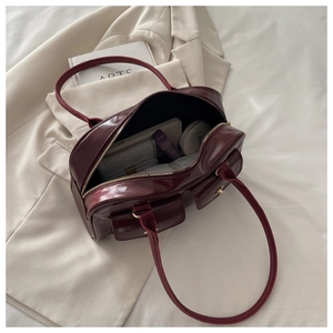 Interior view of deep red glossy leather handbag showing spacious storage capacity