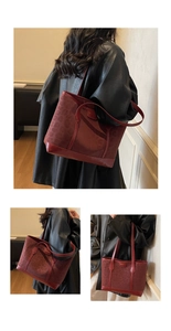Detail of dark red leopard print tote bag with metallic logo and dual carry handles