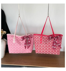Detail of red and pink bridal tote bags with woven double happiness pattern and silk bows
