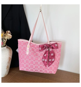 Pink festive tote bag with traditional pattern and a decorative deep red bow ribbon