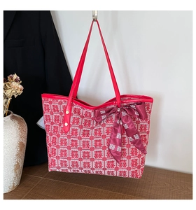 Detail of red bow and double happiness embroidery on a Chinese style tote bag