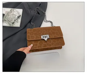 Detail of brown leopard print crossbody bag with vintage metal buckle and chain strap
