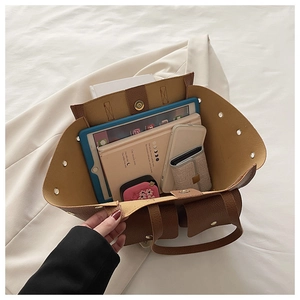 Spacious brown tote bag interior showing capacity for tablets and daily items