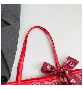 Detailed close-up of festive red tote bag with Double Happiness symbols and ribbon