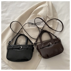 Close-up of black and coffee vintage leather handbags on a stylish blazer background