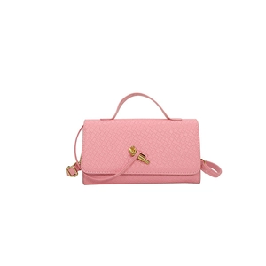 Pink woven texture shoulder bag with gold knot buckle and top handle shown on white