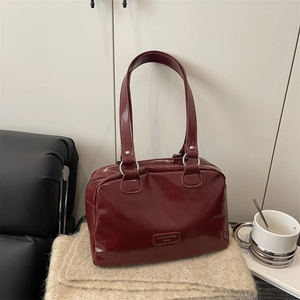 Retro burgundy patent leather shoulder bag with glossy finish and long handle