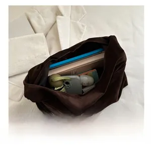 Interior view of large brown suede tote bag showing capacity for tablet and daily items