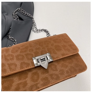 Detail of brown leopard print suede chain bag with elegant silver rectangular lock