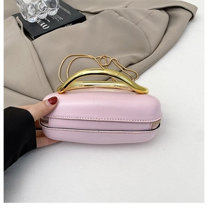 Pink oval hardshell handbag with elegant gold metal arched handle and chain strap
