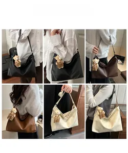 Detail showing high-capacity leather tote bags in three colors with cute bear charms