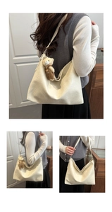 Detail of cream bowling bag with textured leather, long strap and cute bear charm