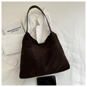 Detailed texture of dark brown faux suede tote bag with stylish vertical stitching