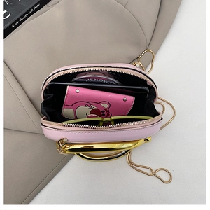 Internal view of pink half-moon crossbody bag showing capacity for phone and wallet