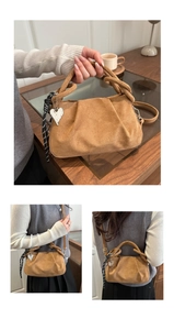 Detail of brown suede dumpling bag with pleated top and silver heart pendant decoration