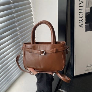 Retro brown faux leather handbag with buckle straps and adjustable shoulder strap