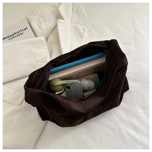 Top view of large brown suede tote bag showing spacious interior with daily essentials