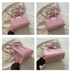Detail view of pink pleated handbag showing PU leather texture and silver hardware accents