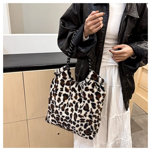 Close-up of leopard print plush tote bag showing soft faux fur texture and rope handles
