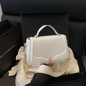 White minimalist shoulder bag with wavy stitching and wide strap in premium gift box