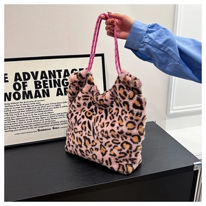 Detail of pink leopard print plush tote bag featuring woven rope handles and metal hardware