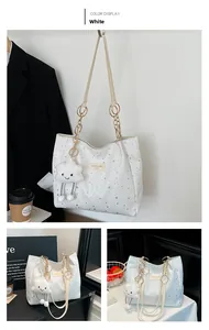 Detail of white tote bag with silver star prints and metal chain shoulder strap