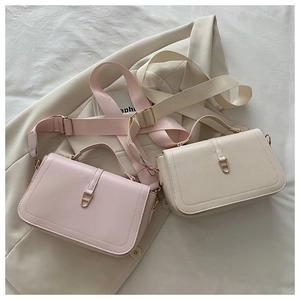 Flat lay of pink and beige square crossbody bags with wide fabric shoulder straps