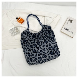 Detail of plush leopard print tote bag featuring a thick blue and black rope handle