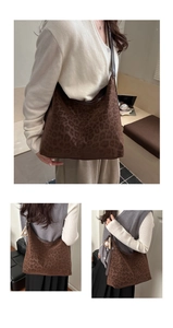 Detail view of leopard print hobo bag with leather strap and baseball charm ornament