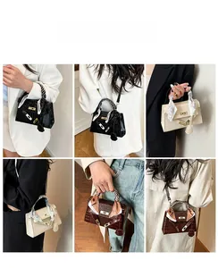 Detail view of crocodile pattern crossbody bags with decorative scarves in various colors