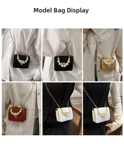 Detailed view of mini woven crossbody bags with pearl heart decor in multiple colors