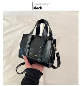Macro detail of black tote bag with gold Fashion & Bags lettering and dual handles