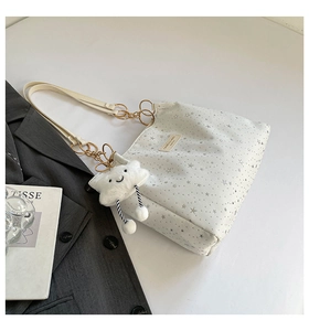 White tote bag with silver stars, beige strap, and cute plush cloud charm detail