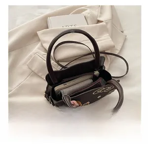 Detailed view of the brown crossbody bag interior showing storage space and zipper pocket