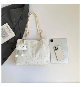 White star-pattern tote bag with gold chain handles and cute cloud plush accessory