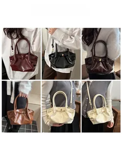 French style glossy bucket bag featuring pleated texture and gold metal hardware detail