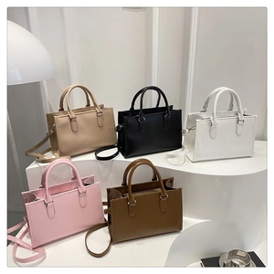 Detailed display of five ribbed PU leather tote bags in beige, black, white, pink and brown