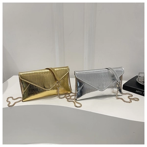 Detail of metallic pleated envelope clutch bags in gold and silver with chain straps