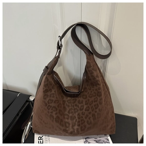 Detail of vintage leopard print hobo bag showing the suede texture and wide shoulder strap